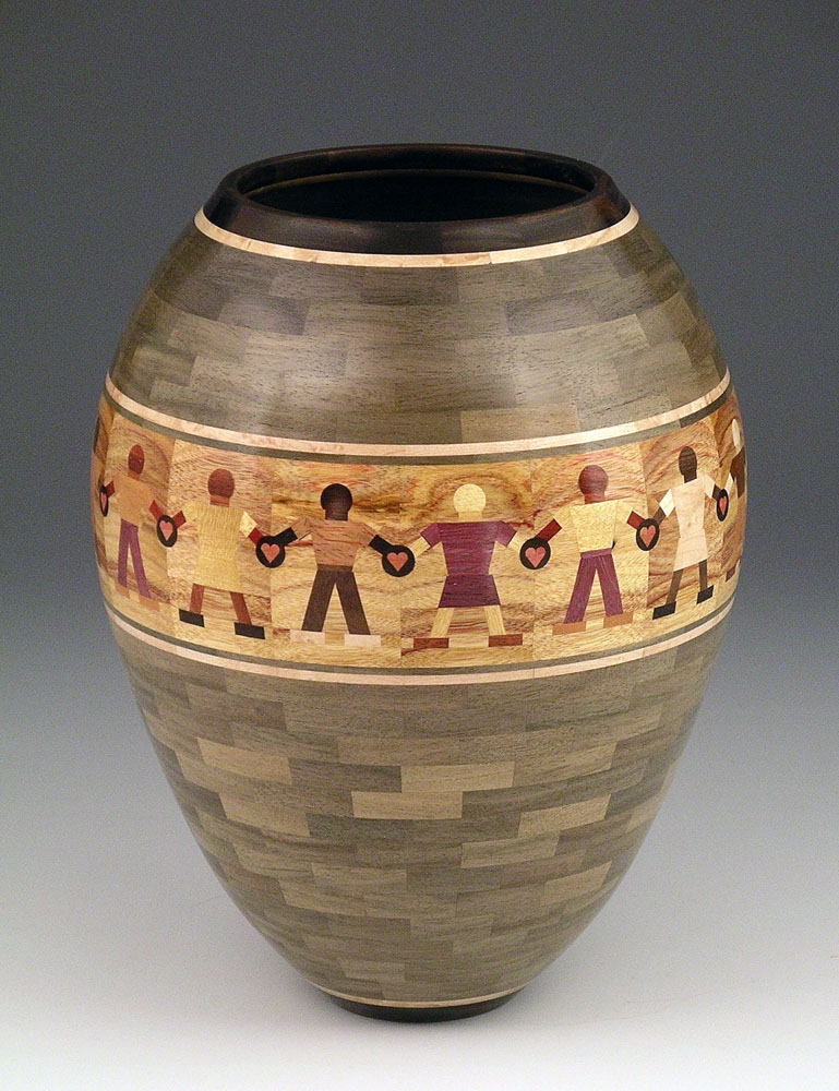 segmented wood turning vase with people holding hands
