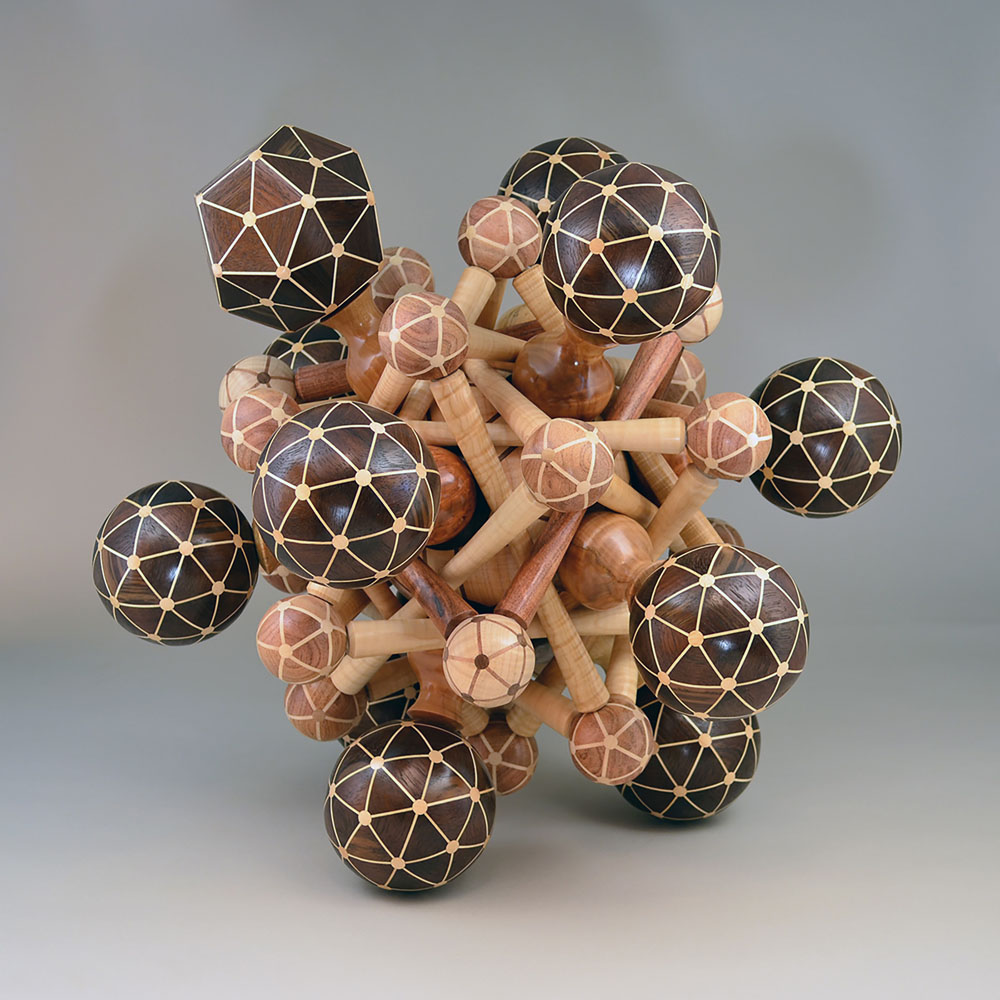 segmented wood turning spheres and rods twisted together in a jumble