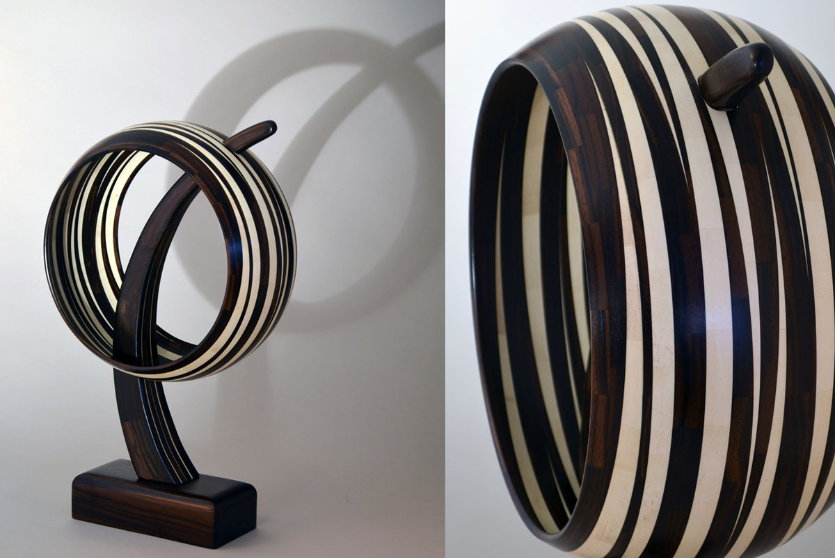 black and white striped wooden ring mounted on a pedestal