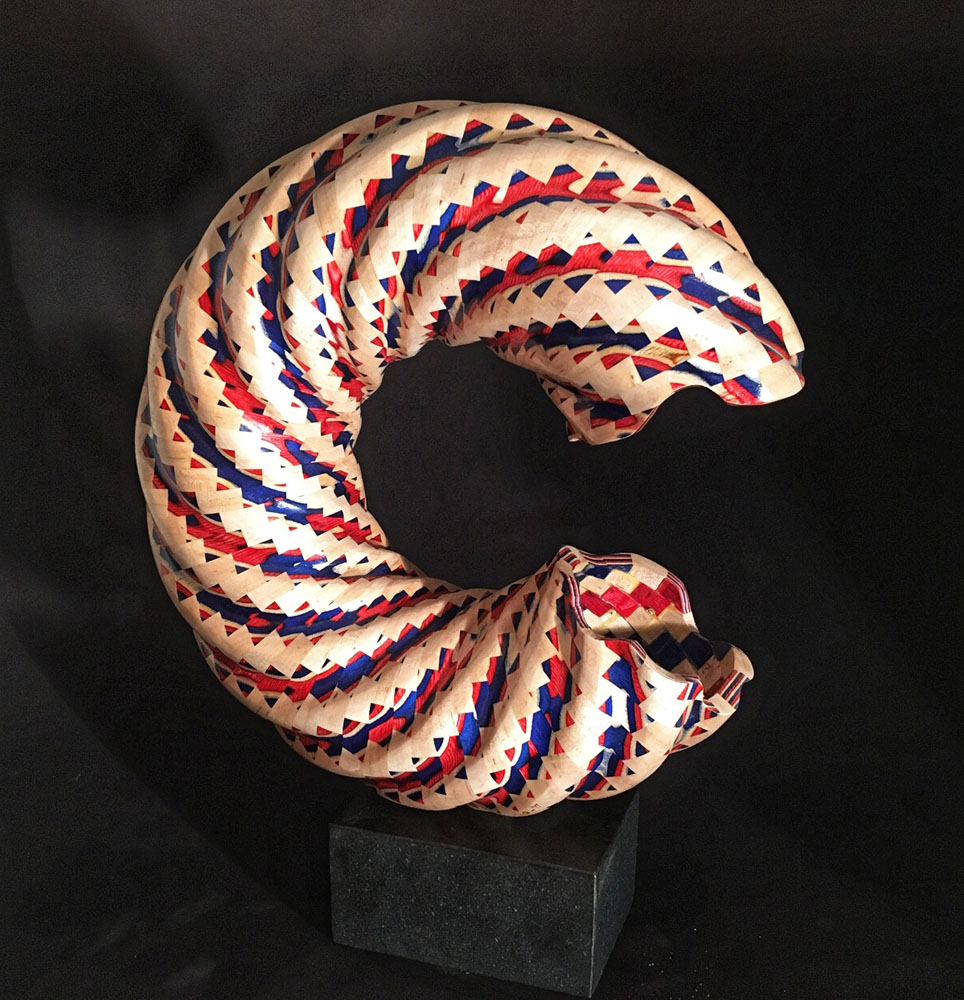 red white and blue crescent shaped segmented wood turning sculpture