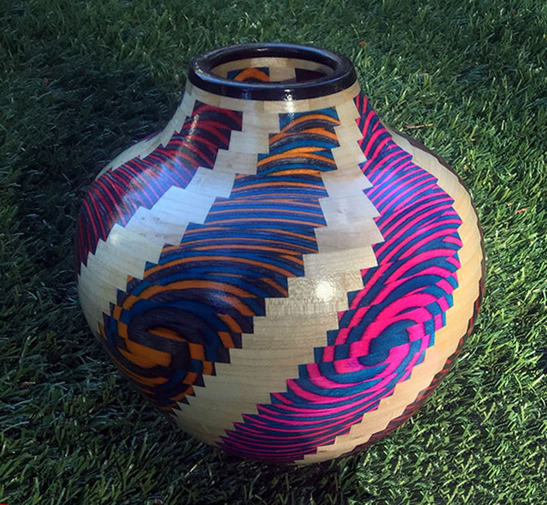 segmented wood turning vase with multi colored pattern
