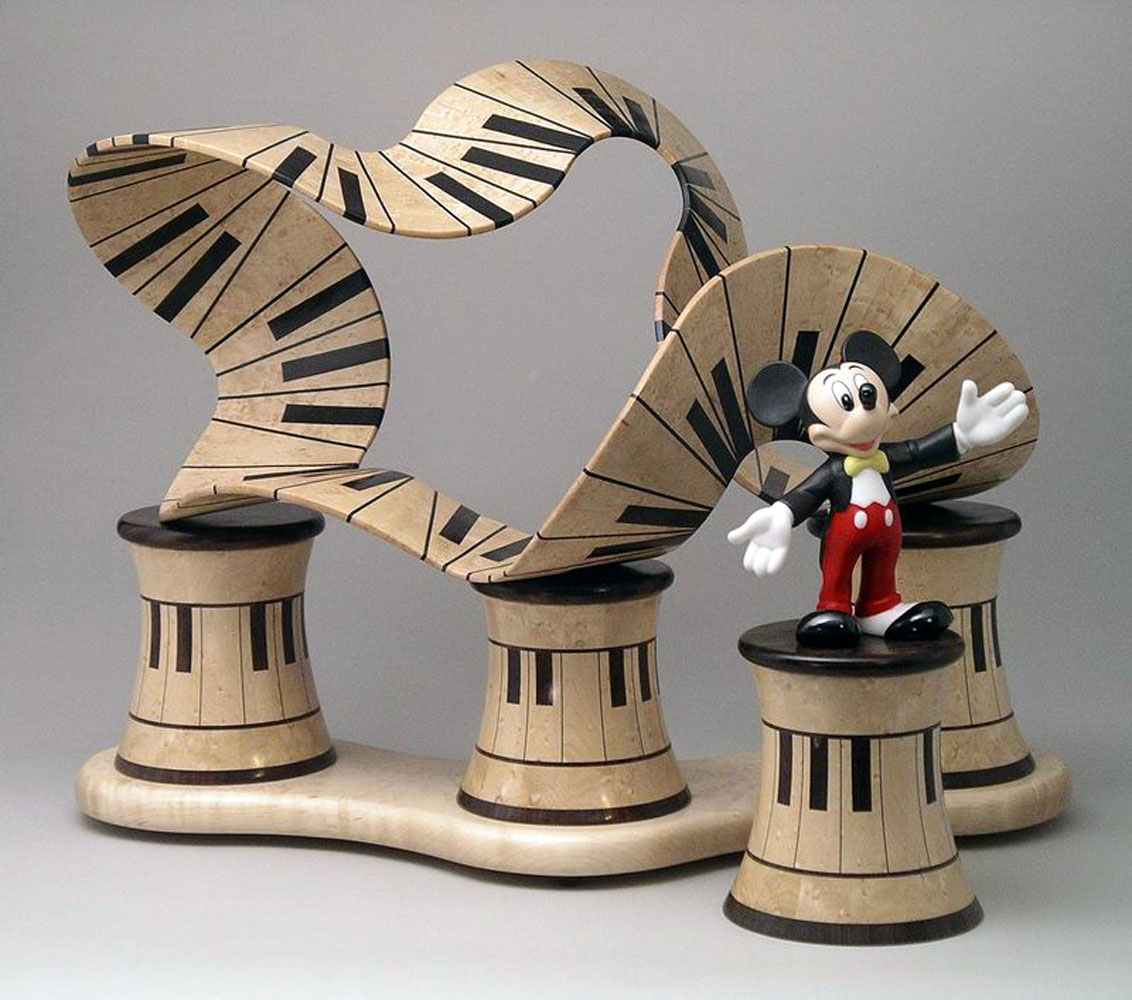 mickey mouse figurine with piano wooden ribbon carving
