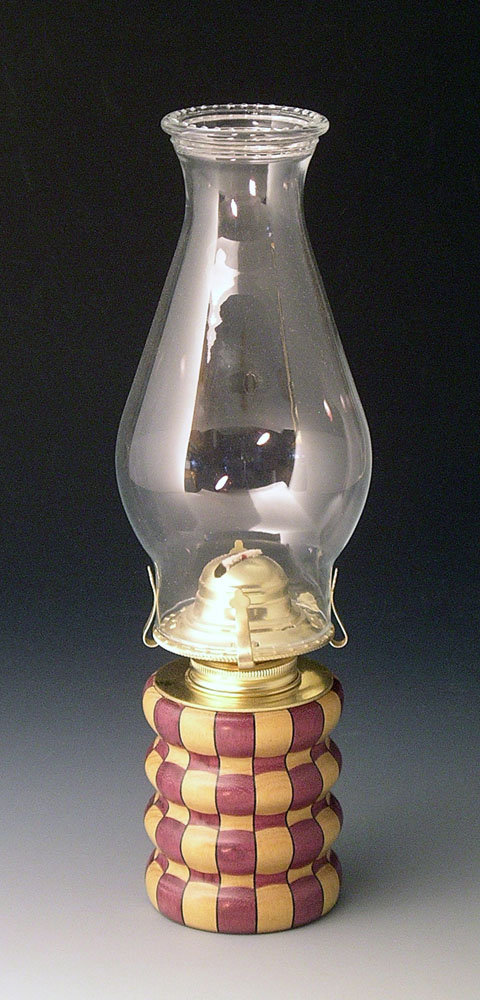 red and brown kerosene lamp with glass shade