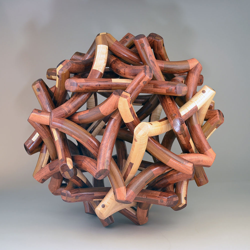 cornered pieces of woods shaped into a sphere using segmented wood turning