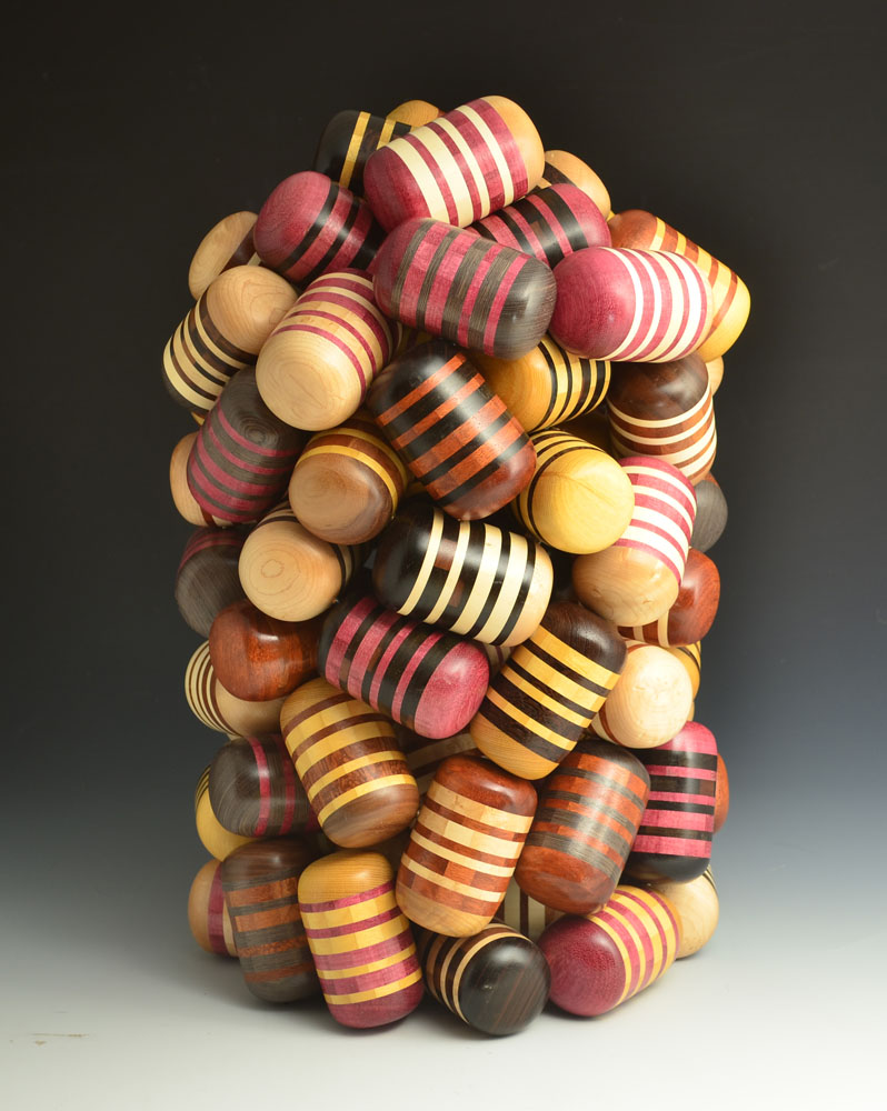 many bright colored wooden pills piled together