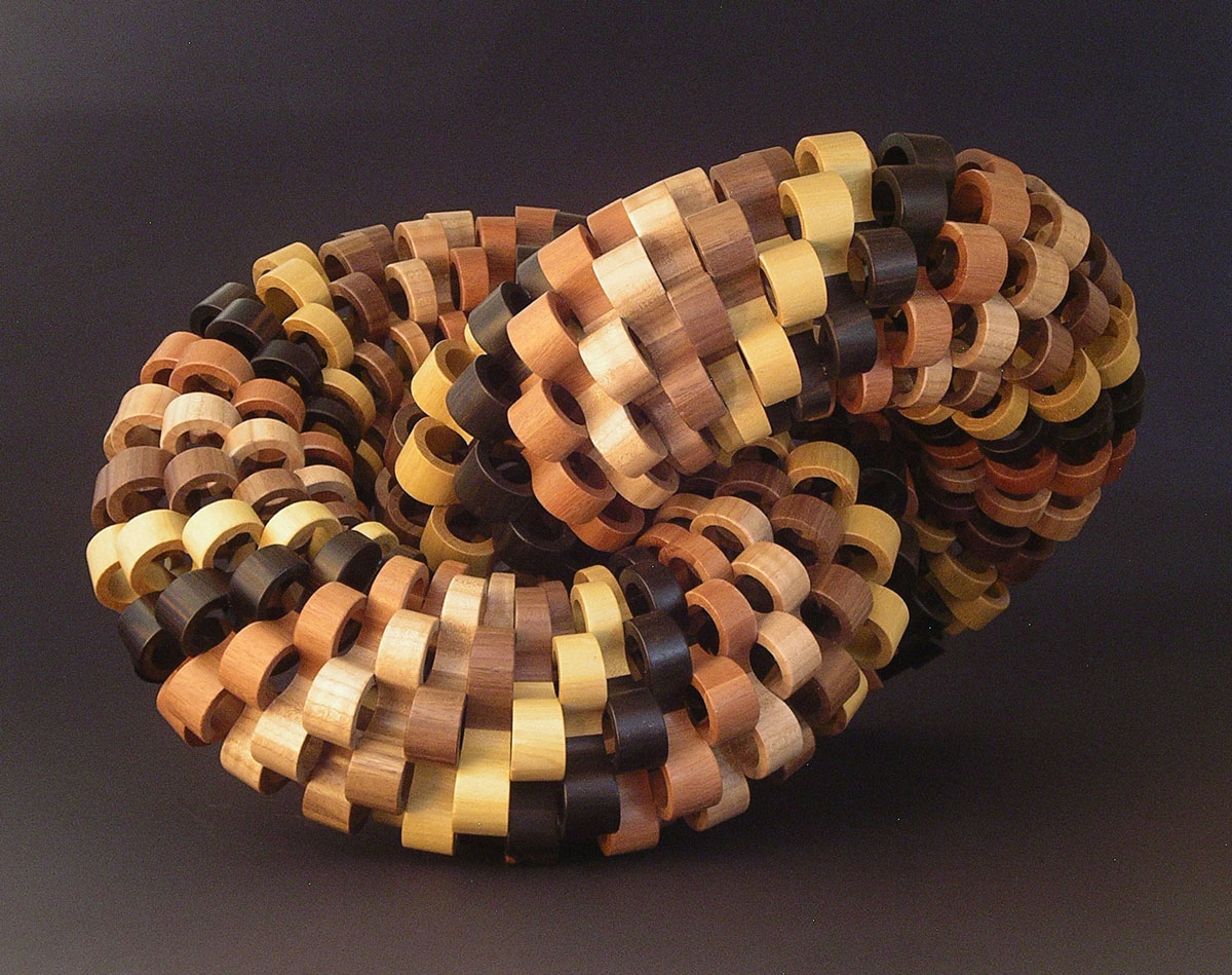 multi colored segmented wood turning links interlocked with eachother