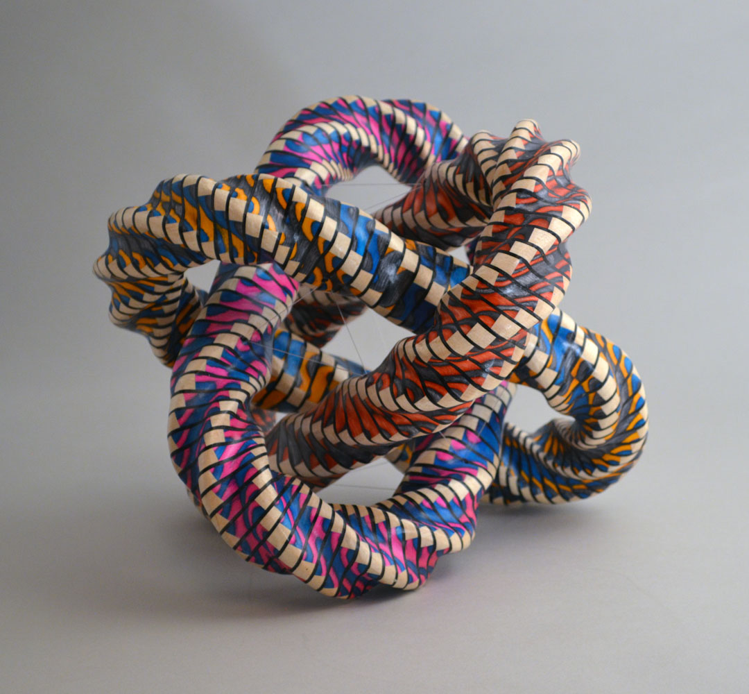 brightly colored painted pieces of wood twisted into a knot