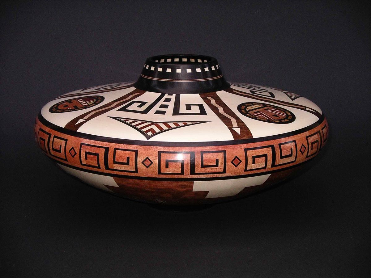squat segmented wood turning vessel with white and brown patterns